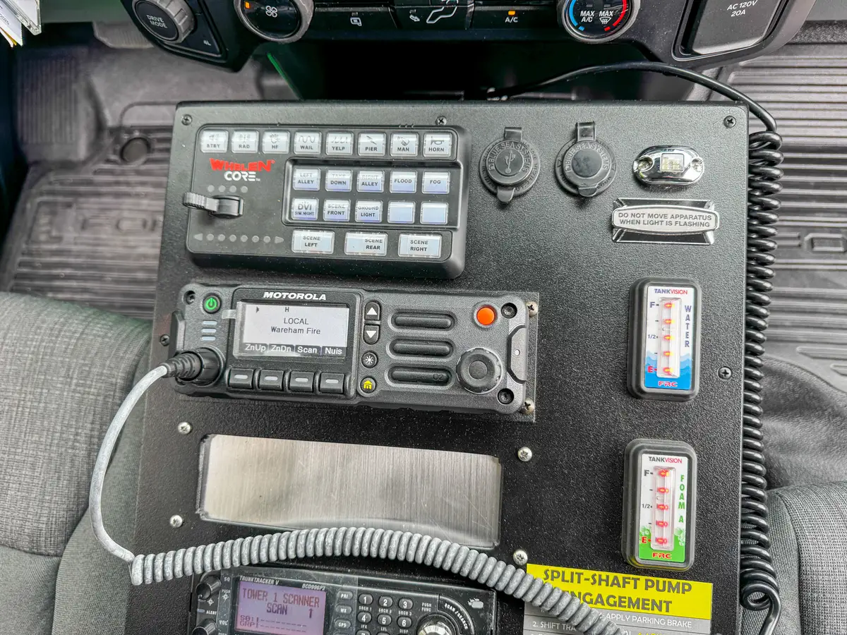 Rear center-console close-up with mounted flashlights and storage cubbies.